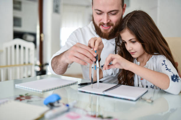 patient bearded father showing daughter how to use drawing compass for math homework - geometry mathematics drawing compass mathematical symbol imagens e fotografias de stock