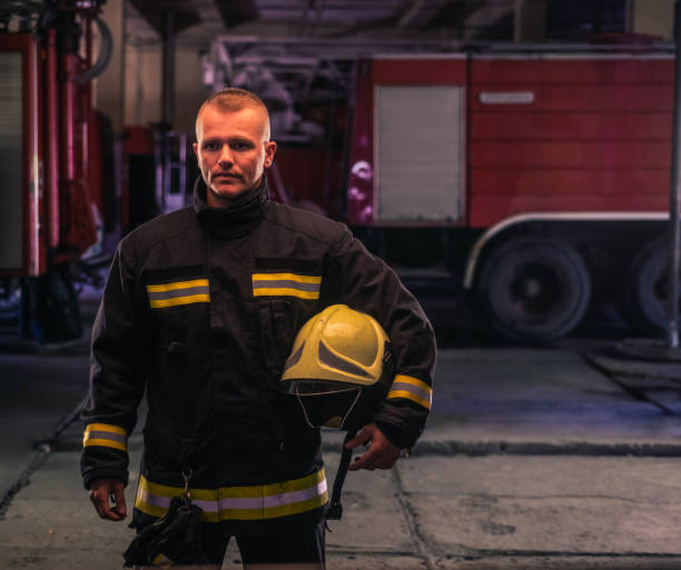 istock Portrait of young fireman standing inside the fire station 1368102203