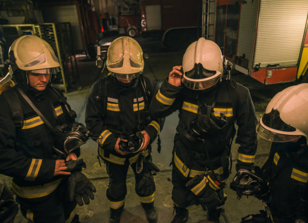 istock Group of firefighters with uniform inside the  fire station preparing for safe rescue 1368102384
