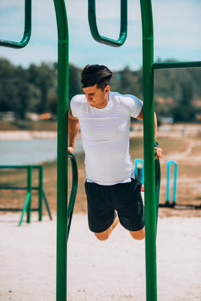 istock Handsome muscular young man have gym training 1368103297