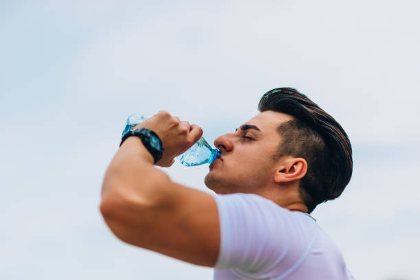 istock Man drinking water from sportive water bottle 1368103426