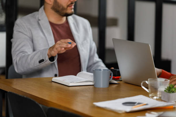 istock Copy space shot of businessman gesturing while explaining his ideas to a colleague 1368104322