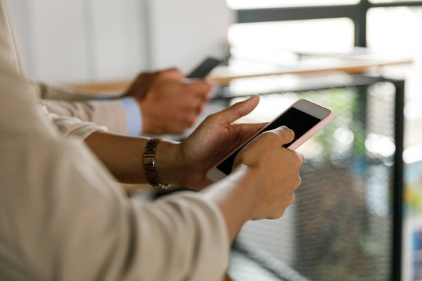 istock Selective focus shot of two business people using their smart phones 1368104342