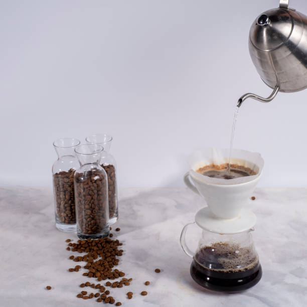 istock Coffee brewing method with v60 dripper, Pouring water into the V60 dripper with kettle 1368105272