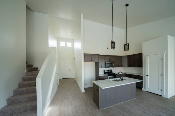 istock New Home Interior Open Concept Living Room with Vaulted Ceilings and Modern Well-Lit Kitchen and Hardwood Floors 1368105572