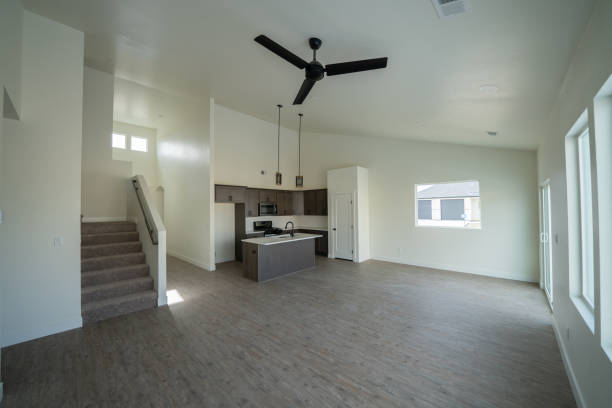 istock New Home Interior Open Concept Living Room with Vaulted Ceilings and Modern Well-Lit Kitchen and Hardwood Floors 1368105589