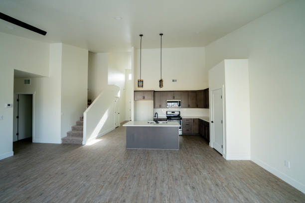 istock New Home Interior Open Concept Living Room with Vaulted Ceilings and Modern Well-Lit Kitchen and Hardwood Floors 1368105593