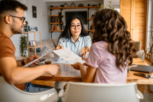 istock Couple talking to finance advisor at home 1368105594