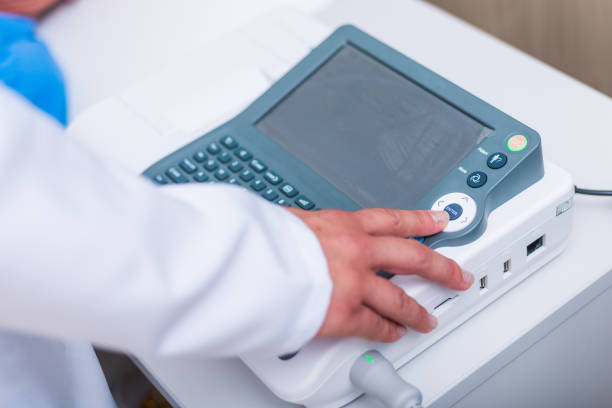 istock Close up photo on a EKG machine while an older man gets his heart checked. 1368105622