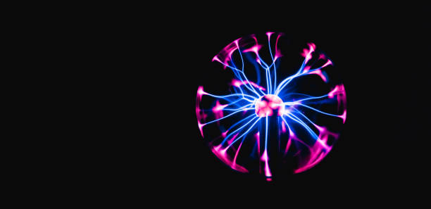 istock An electrically charged night lamp shines with a blue-pink light on a black background 1368106619