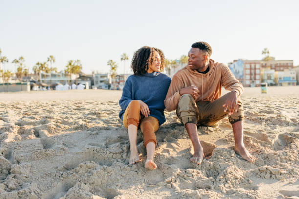 istock Smiling couple on the beach - joyful moment 1368107483