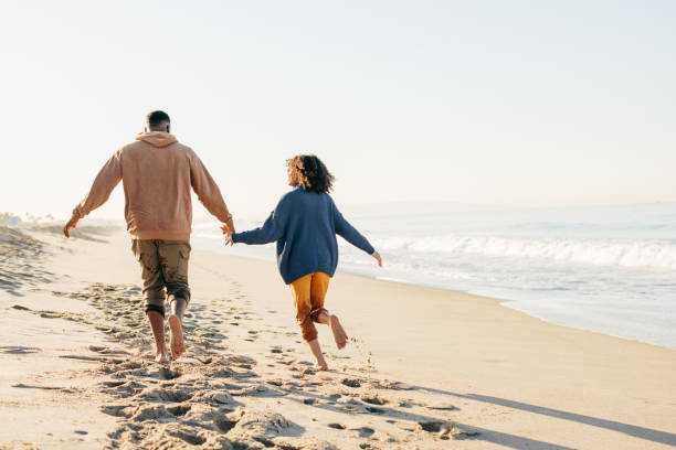 istock Smiling couple on the beach - joyful moment 1368107508