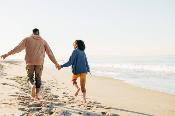 istock Smiling couple on the beach - joyful moment 1368107509