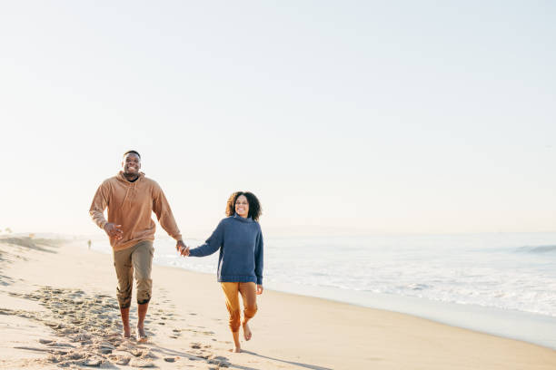 Smiling couple on the beach - joyful moment