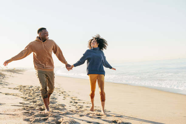 istock Smiling couple on the beach - joyful moment 1368107519