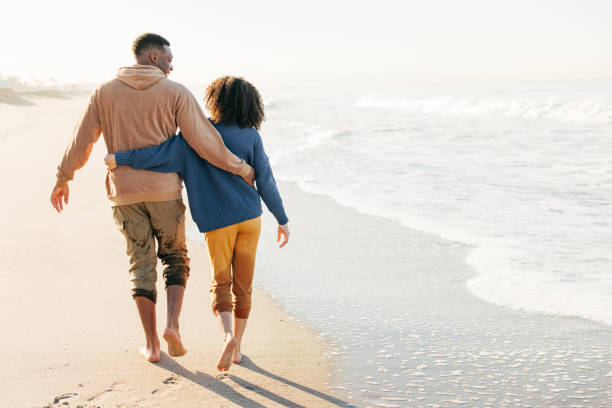 istock Smiling couple on the beach - joyful moment 1368107520
