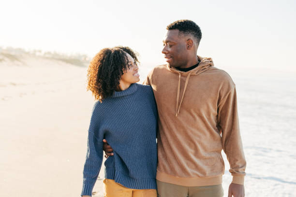 istock Smiling couple on the beach - joyful moment 1368107522