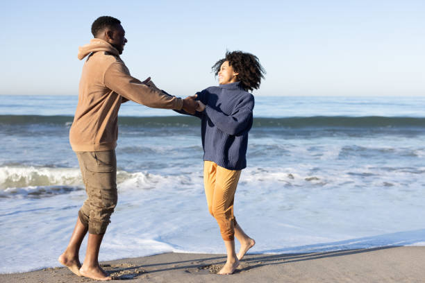istock Smiling couple on the beach - joyful moment 1368107536