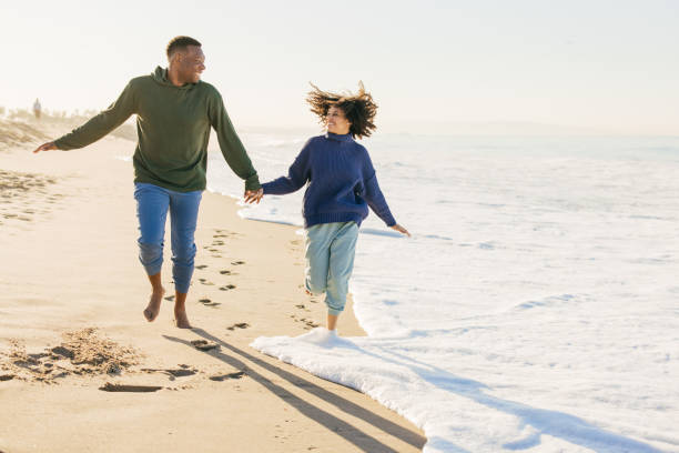 istock Smiling couple on the beach - joyful moment 1368107566