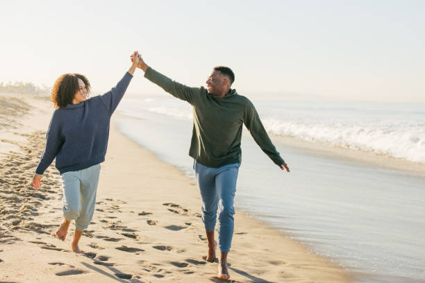 istock Smiling couple on the beach - joyful moment 1368107572