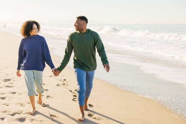 istock Smiling couple on the beach - joyful moment 1368107590