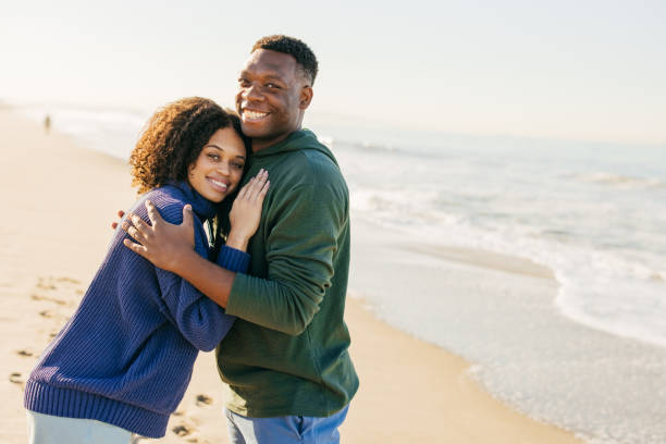istock Smiling couple on the beach - joyful moment 1368107592