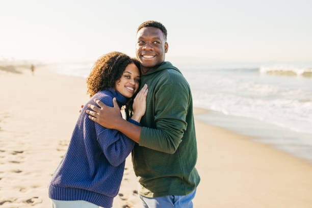 istock Smiling couple on the beach - joyful moment 1368107602