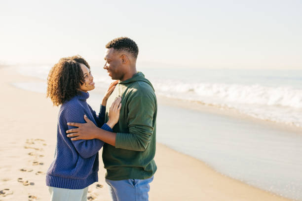 istock Smiling couple on the beach - joyful moment 1368107605