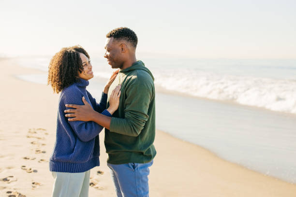 istock Smiling couple on the beach - joyful moment 1368107606