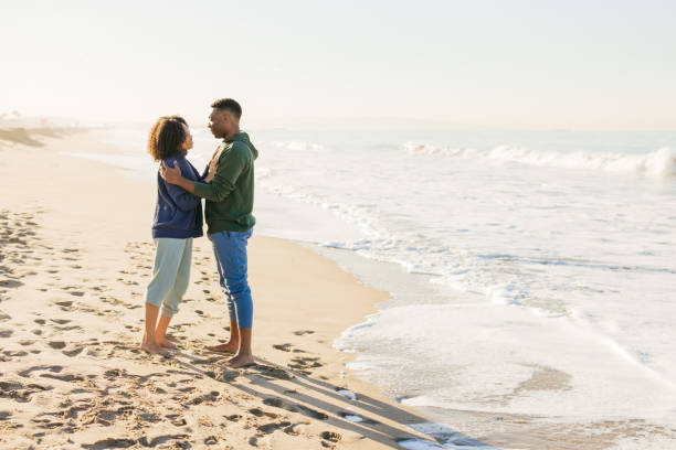 istock Smiling couple on the beach - joyful moment 1368107609