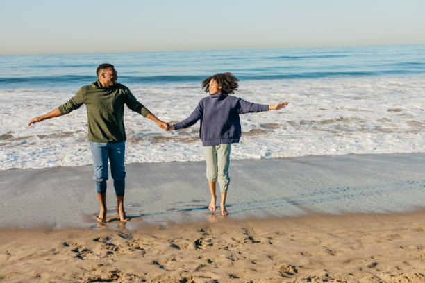 istock Smiling couple on the beach - joyful moment 1368107666
