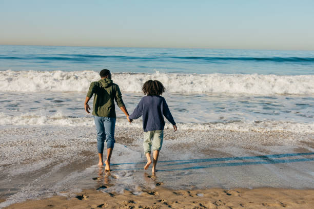 istock Smiling couple on the beach - joyful moment 1368107705