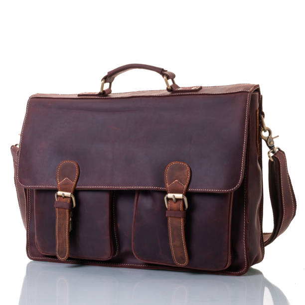 istock Brown leather briefcase with pockets. One handle and shoulder strap. Flap with fasteners. Brass fittings 1368109111