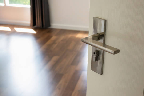 istock Modern door handle on white door with room interior 1368110670