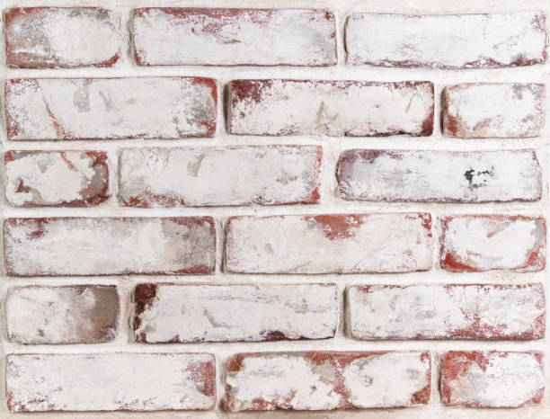 istock Grungy brick wall with remnants of whitewash and natural defects, front view. It can be used as background and for posters, wallpapers and other design ideas. Preparation for repair 1368111029