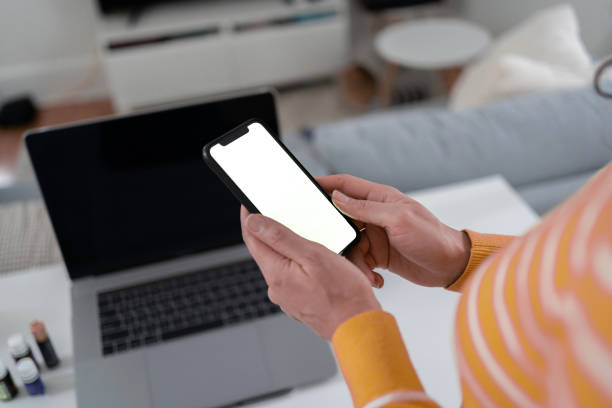 istock Woman with smartphone in hand at home 1368114578