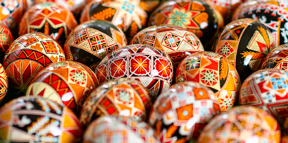 Decorated eggs for Easter lie on a white background. Decorations for Easter - symbolism - colored eggs. Quail eggs at the point are painted in different colors.