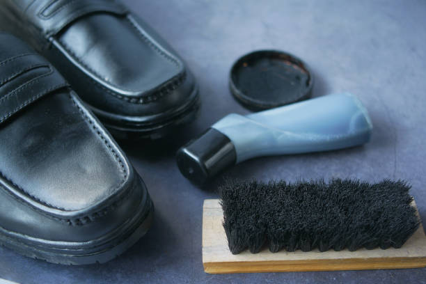 istock cleaning Shoe with a brush on floor 1368122190