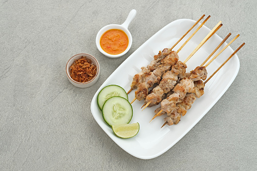 Sate Taichan, Grilled Chicken Satay without peanut sauce or soy sauce. Served on plate with sambal (chilli sauce). Selected focus.