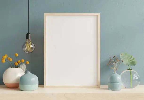 Photo of Poster mockup with wooden frame in home interior background.