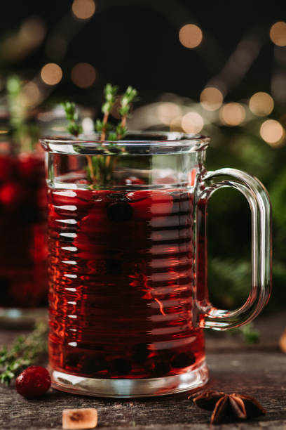 istock Winter beverage with cranberry and traditional spices on the rustic background with christmas decorations. Selective focus. 1368131821