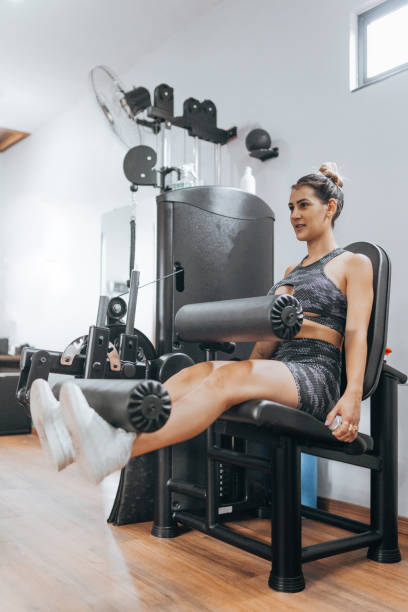 istock Female athlete exercising legs on the extensor 1368132883