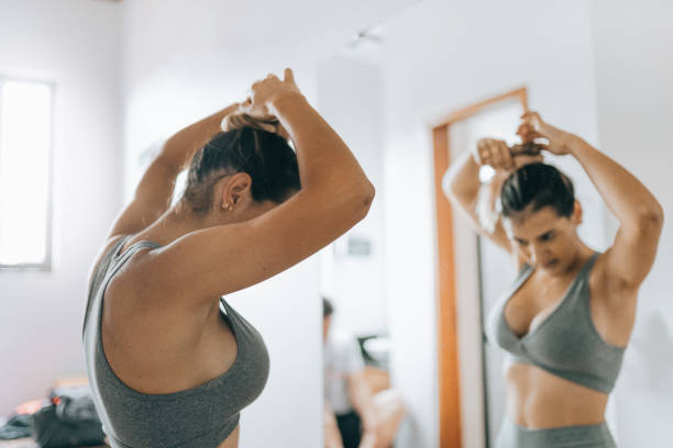 istock Female athlete pinning hair to start training 1368132884