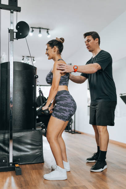istock Bodybuilding instructor checking posture of athlete in weightlifting 1368132902
