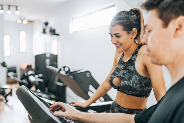 istock Fitness instructor programming treadmill for woman 1368133450