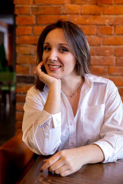 istock Young woman sits in a cafe at a table on the couch. Waiting for breakfast. 1368133782