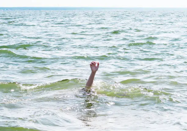 Person with Hand Up in the Water