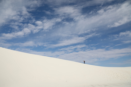 A Hiker on the Sand Dune Ridge at White Sands National Park\nAlkali Flat Trail is a 5-mile loop trail into the heart of White Sands Dunes.\nNew Mexico