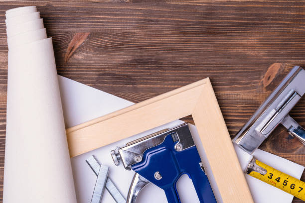istock Print photos on canvas. A tool for stretching canvas on a wooden stretcher. Forceps, stapler for staples, measuring tape and a roll of canvas. 1368146426