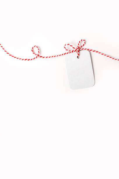 istock White greeting card on white-red holiday ribbon 1368148547